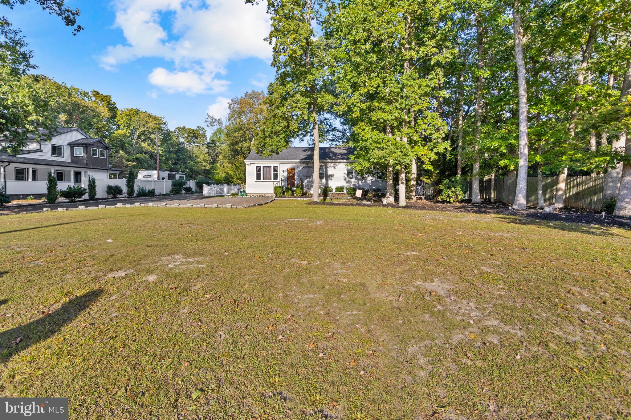 450 Stokes Road Shamong, NJ 08088 - Photo 25 of 35 a yellow house with trees in front of it