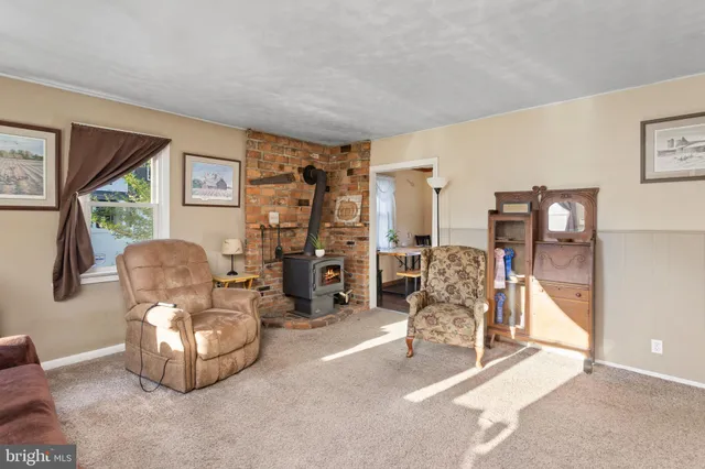a living room with furniture gym equipment and a large window
