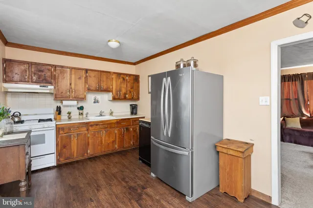 a kitchen with stainless steel appliances a refrigerator and a stove top oven
