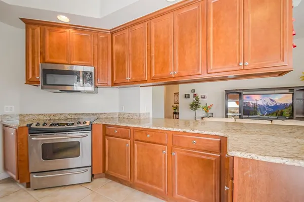 a kitchen with granite countertop cabinets stainless steel appliances and sink