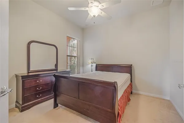 a spacious bathroom with a toilet a sink and mirror