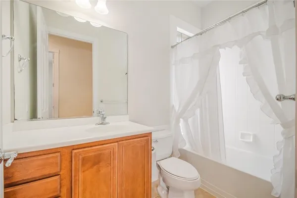 a bedroom with a large bed and a potted plant