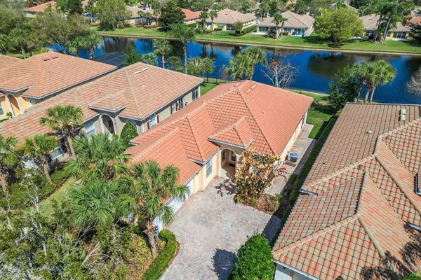 a view of a multi story residential apartment building in a yard with potted plants