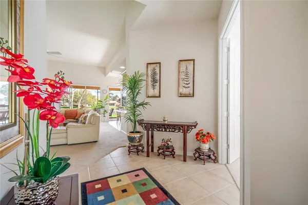 a living room with furniture and flowers