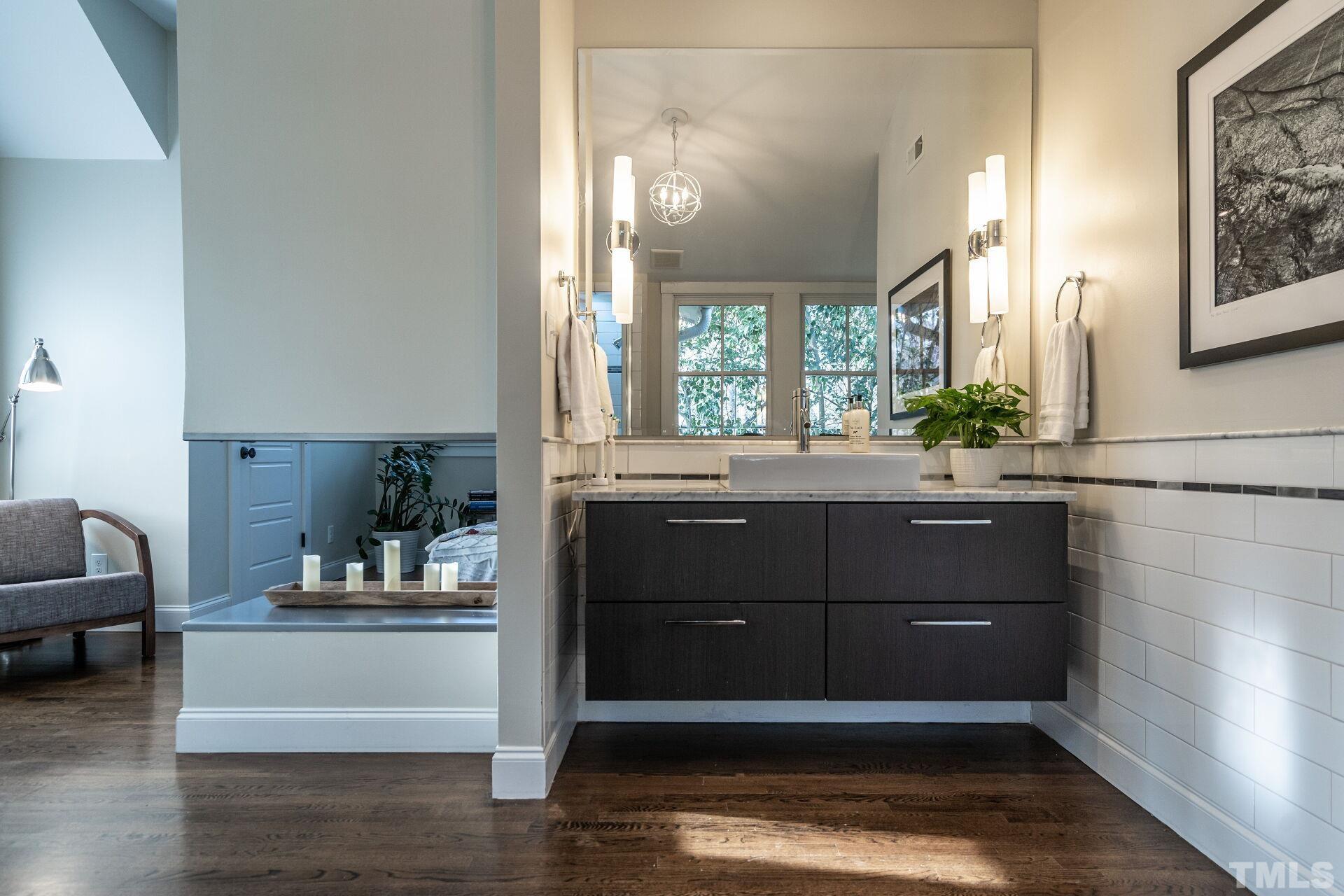 2802 Wayland Drive Raleigh, NC 27608 - Photo 24 of 37 a bathroom with a bathtub a sink and a window
