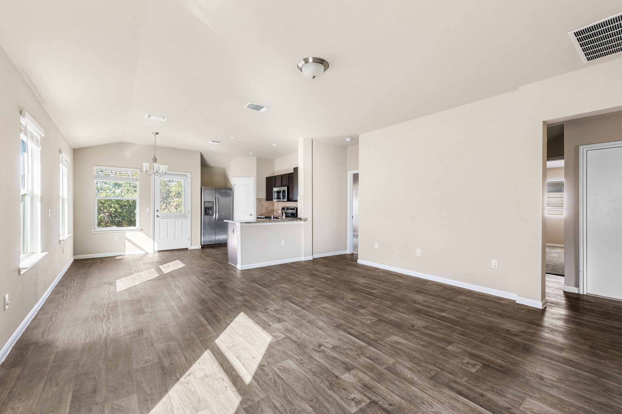 910 Comal Run Hutto, TX 78634 - Photo 4 of 25 Luxury vinyl plank flooring flows throughout living areas.