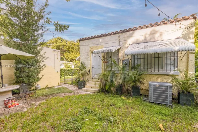 a view of a backyard with plants and a patio