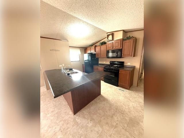 3251 E Road, Unit 11 Clifton, CO 81520 - Photo 4 of 15 a living room with stainless steel appliances kitchen island granite countertop a stove a sink a refrigerator and dishwasher