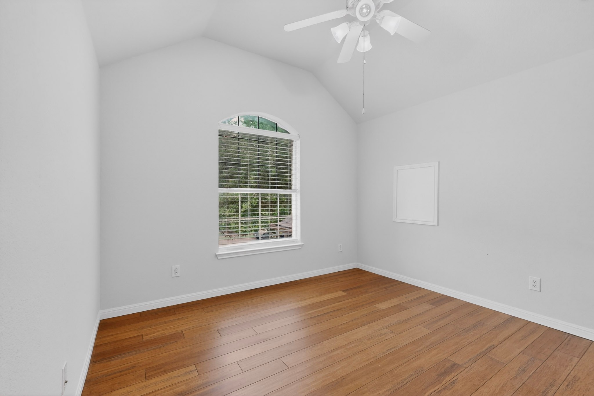8617 Cobblestone Austin, TX 78735 - Photo 26 of 39 an empty room with wooden floor chandelier fan and window