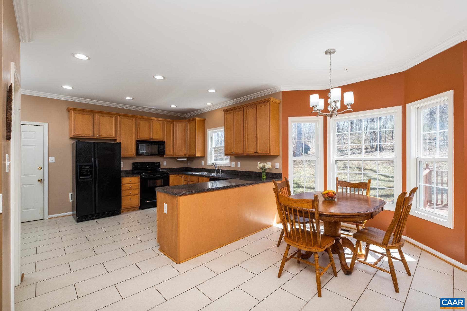 396 Riding Trail Lane Madison, VA 22727 - Photo 18 of 52 a kitchen with stainless steel appliances kitchen island granite countertop a refrigerator and a stove top oven