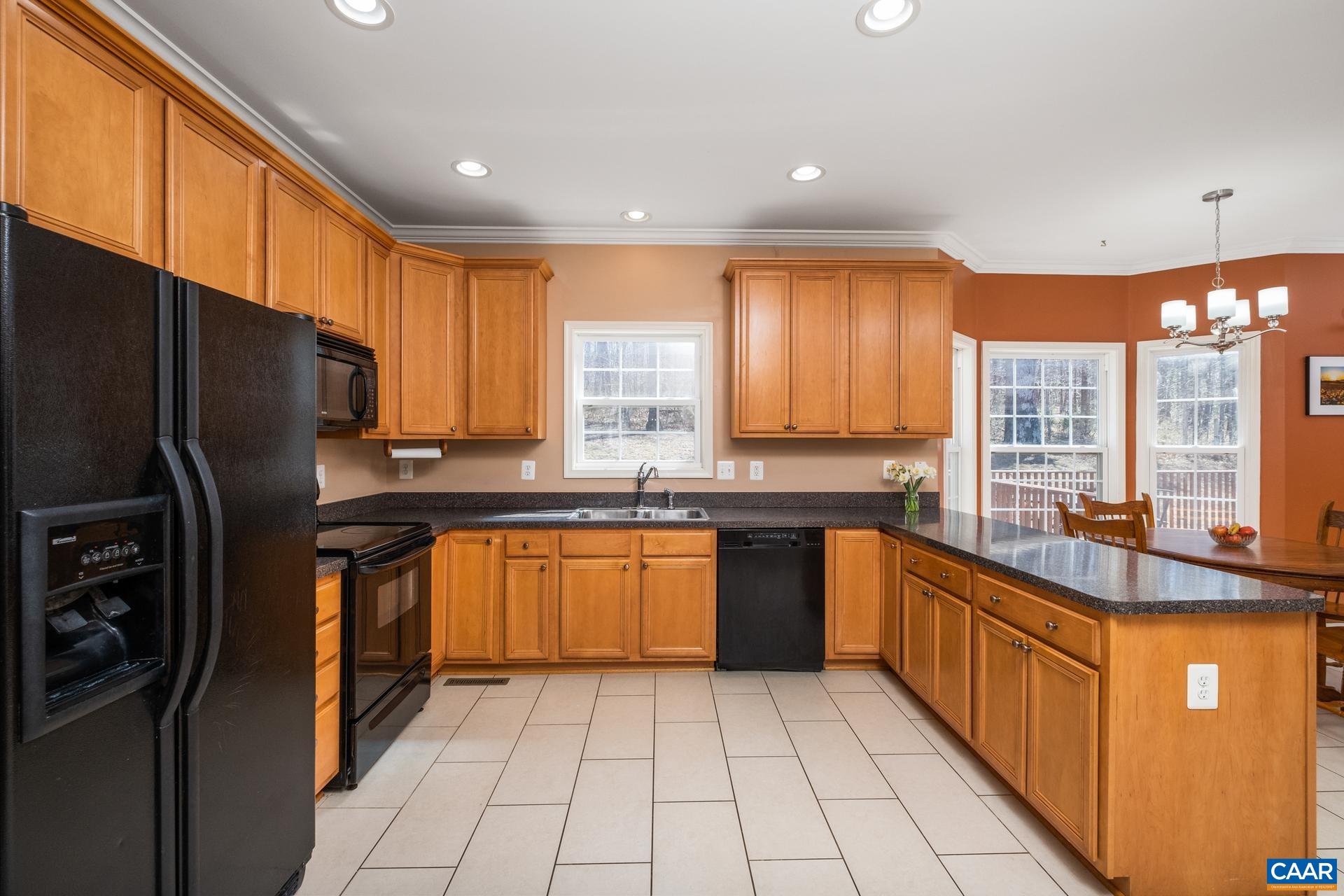 396 Riding Trail Lane Madison, VA 22727 - Photo 20 of 52 a large kitchen with stainless steel appliances granite countertop a stove a sink dishwasher a refrigerator and wooden cabinets