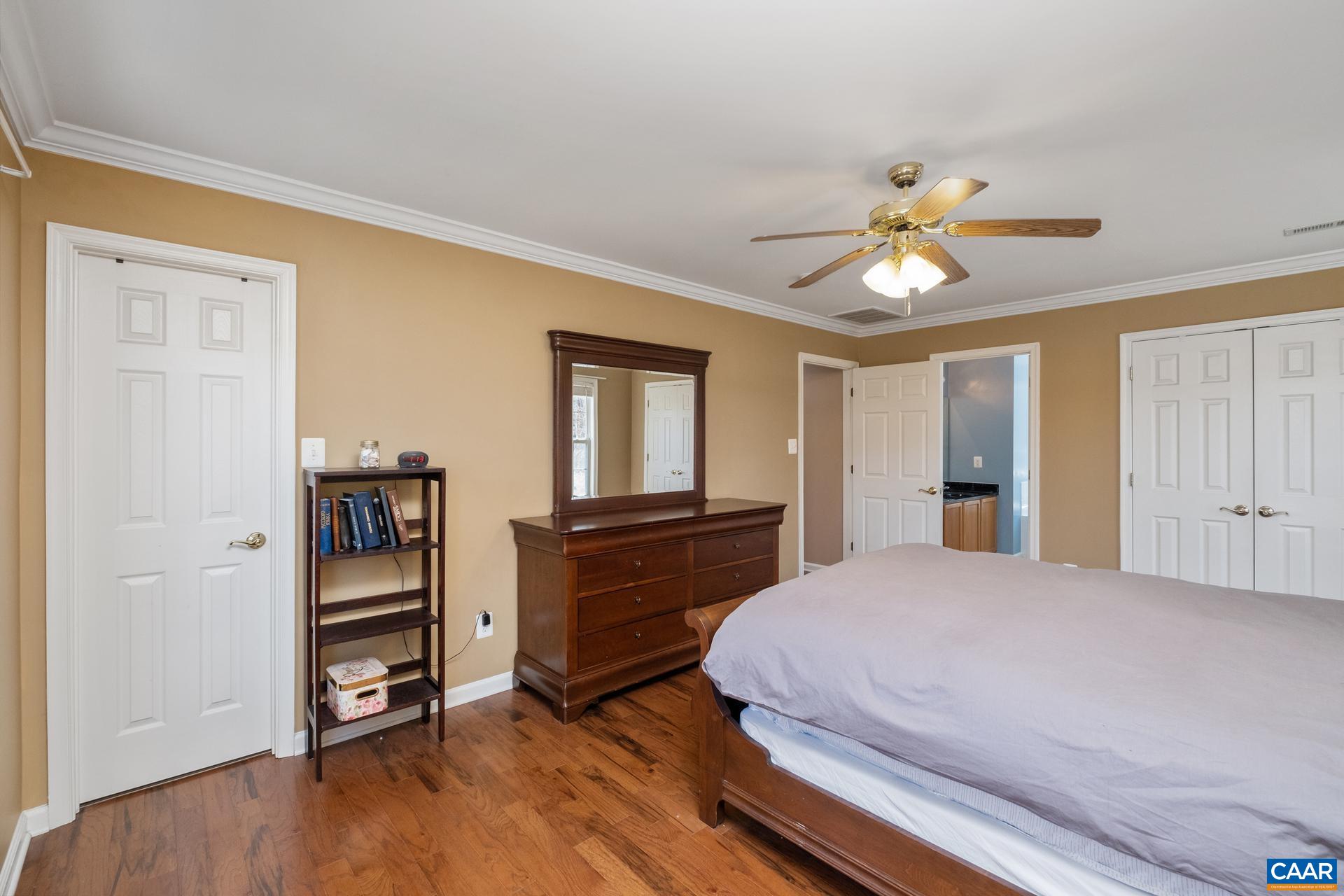396 Riding Trail Lane Madison, VA 22727 - Photo 26 of 52 a bedroom with a bed and a chandelier