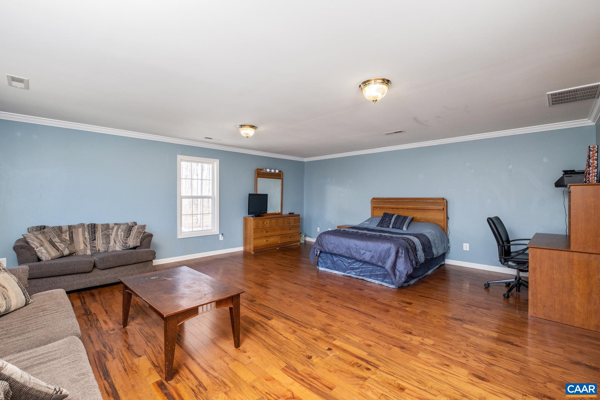 396 Riding Trail Lane Madison, VA 22727 - Photo 36 of 52 a bedroom with furniture and wooden floor