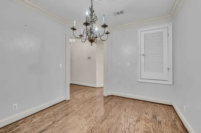 a view of a chandelier fan and wooden floor