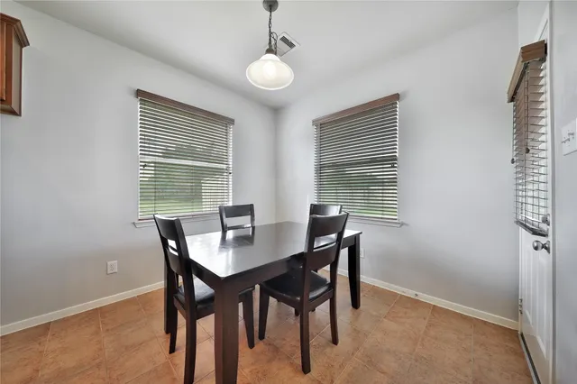 a view of a dining room with furniture and window