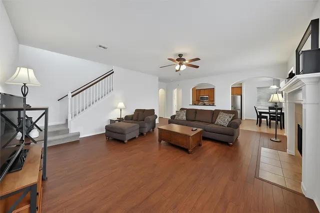 a living room with furniture and a wooden floor