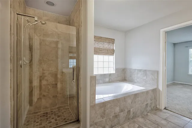 a bathroom with a bathtub and shower