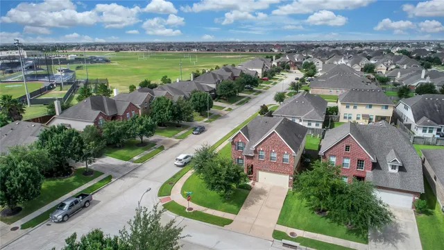 an aerial view of a house with outdoor space and lake view in back