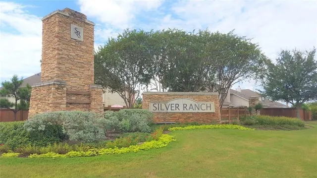 a view of a street sign under a large tree