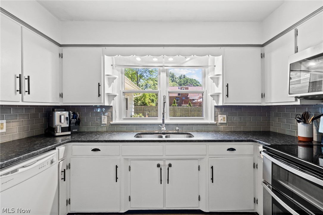 3137 West Edgerton Road Stow, OH 44224 - Photo 13 of 45 Bright white cabinetry and a lovely window to view the backyard.