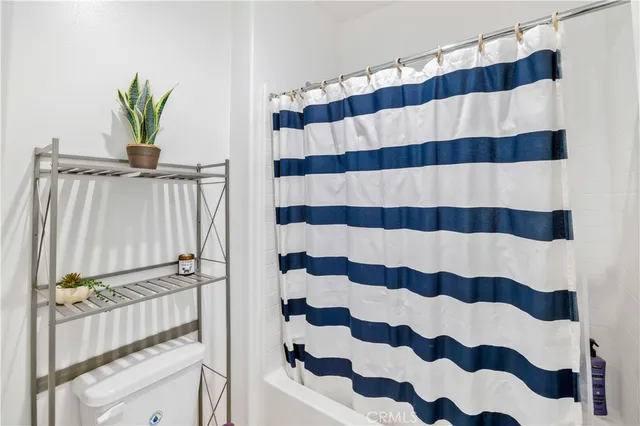 a view of a bathroom with a shower and a mirror