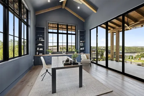 a living room with furniture and a floor to ceiling window