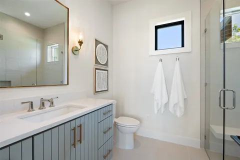 a bathroom with a toilet sink shower and mirror