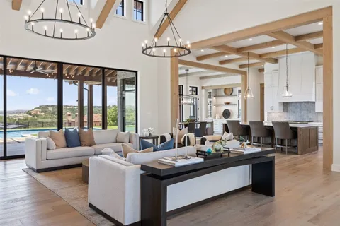 a living room with fireplace furniture and a large window