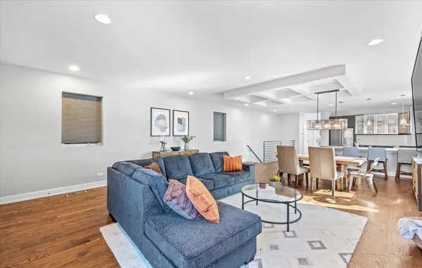 a living room with lots of furniture and a wooden floor