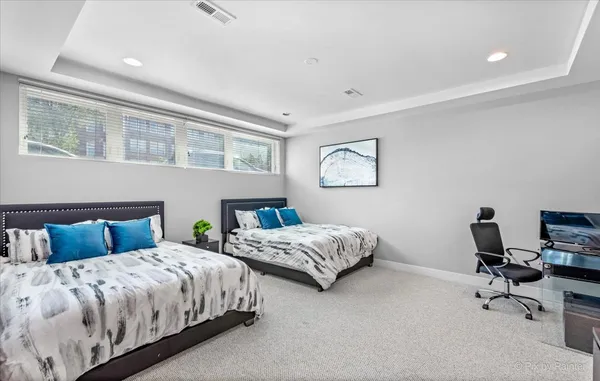 a bedroom with two beds and a desk