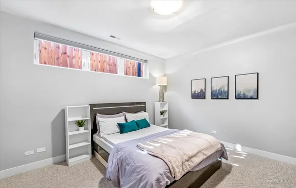 a bedroom with a bed and window