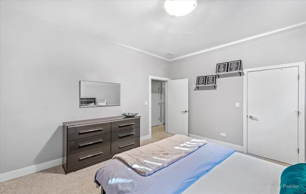 a bedroom with a bed and a dresser in it