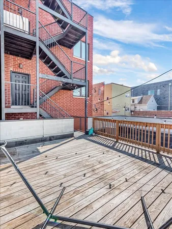a view of a balcony with chair and wooden floor