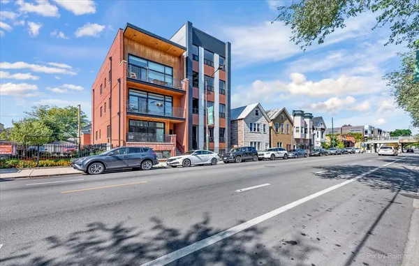 a view of a street with a building in the background
