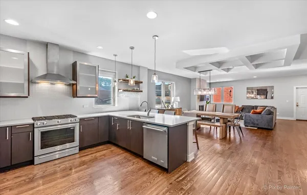 a kitchen with lots of counter top space and stainless steel appliances