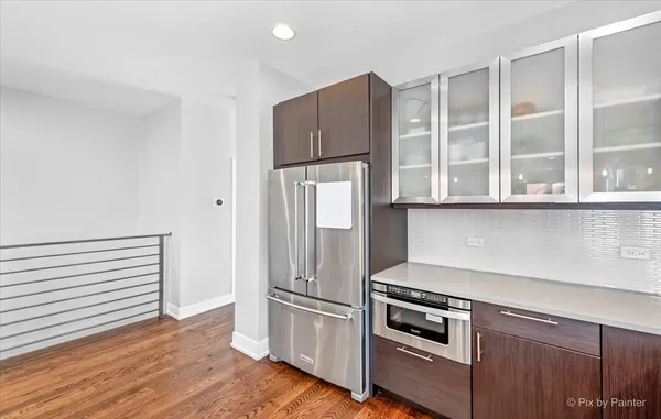 a kitchen with stainless steel appliances granite countertop a refrigerator and a stove top oven