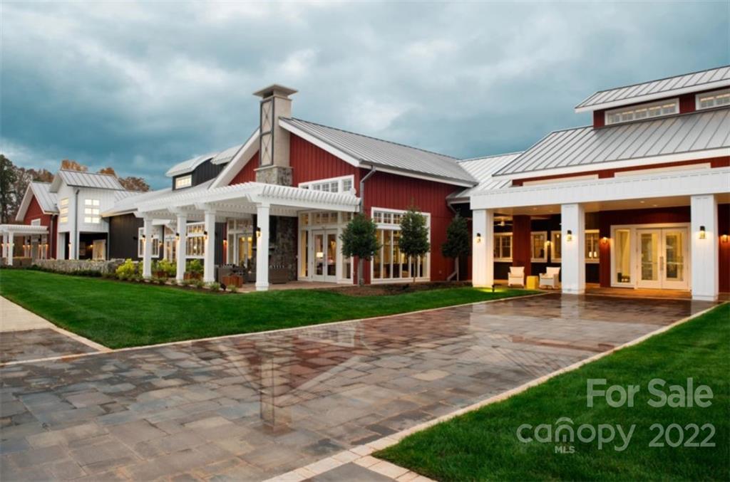 6136 Pier Drive, Unit 1139 Denver, NC 28037 - Photo 8 of 12 a view of a big house with a big yard and potted plants