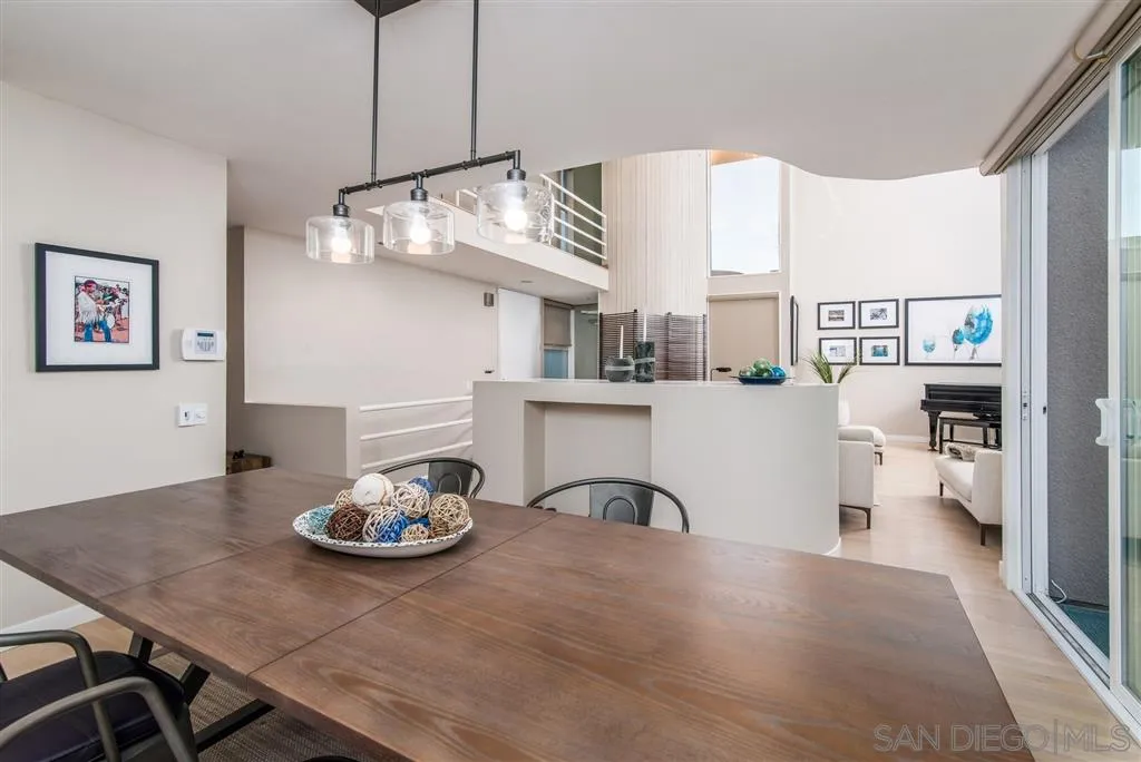 2134 Cordero Road Del Mar, CA 92014 - Photo 11 of 25 a kitchen with stainless steel appliances a table and chairs in it