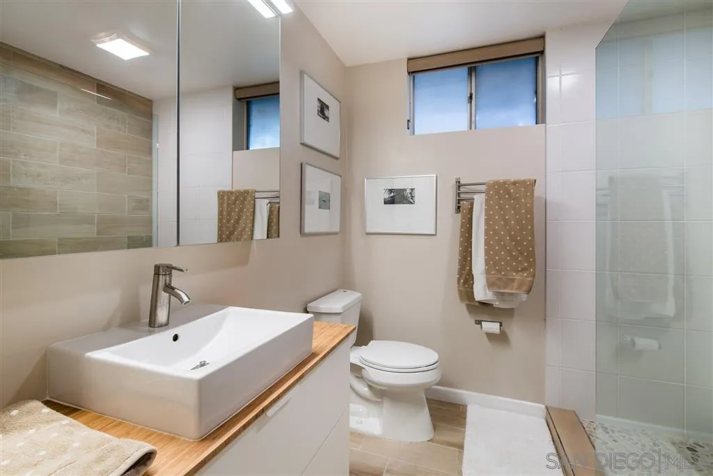 2134 Cordero Road Del Mar, CA 92014 - Photo 14 of 25 a white toilet sitting next to a bathroom sink