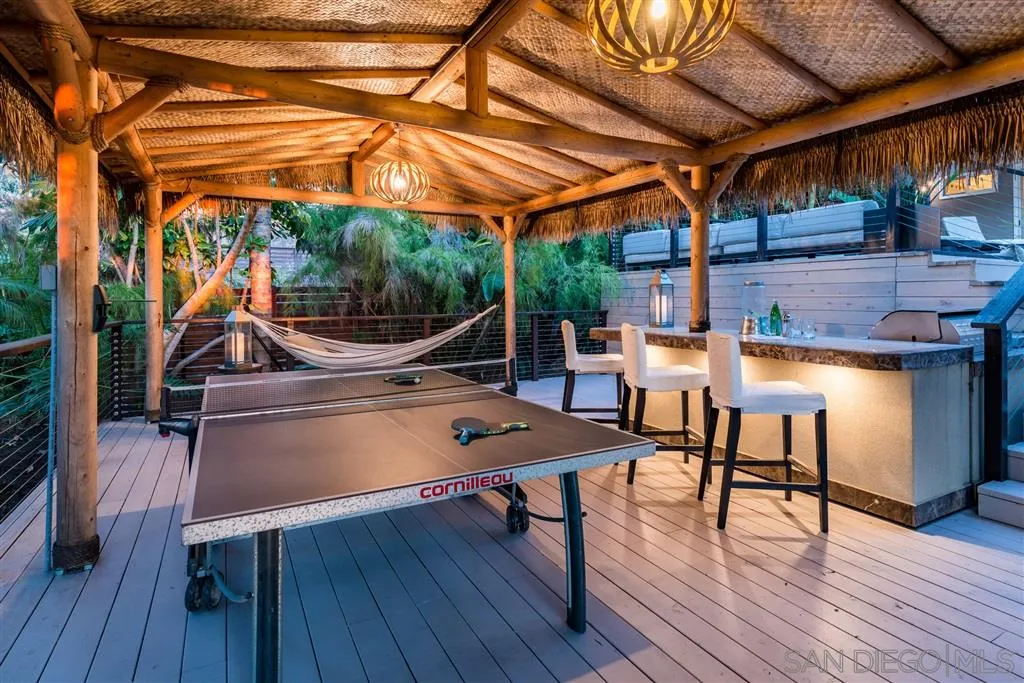2134 Cordero Road Del Mar, CA 92014 - Photo 19 of 25 a view of a patio with table and chairs with wooden floor and fence