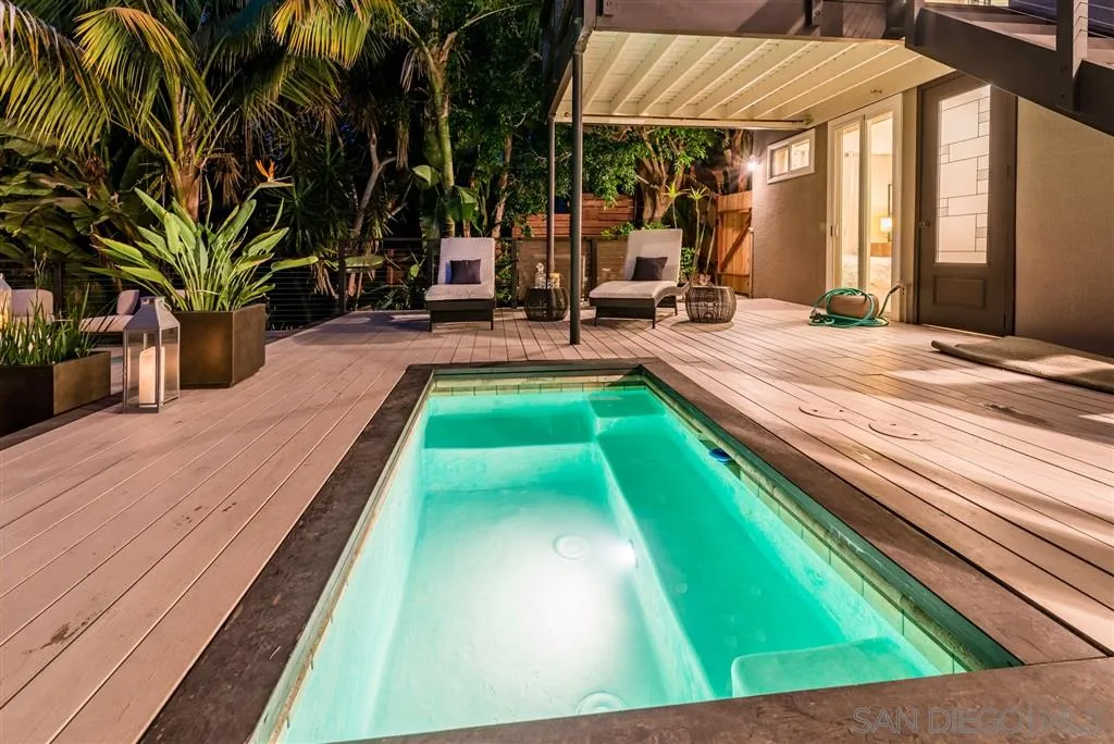 2134 Cordero Road Del Mar, CA 92014 - Photo 21 of 25 a view of swimming pool with lawn chairs under an umbrella