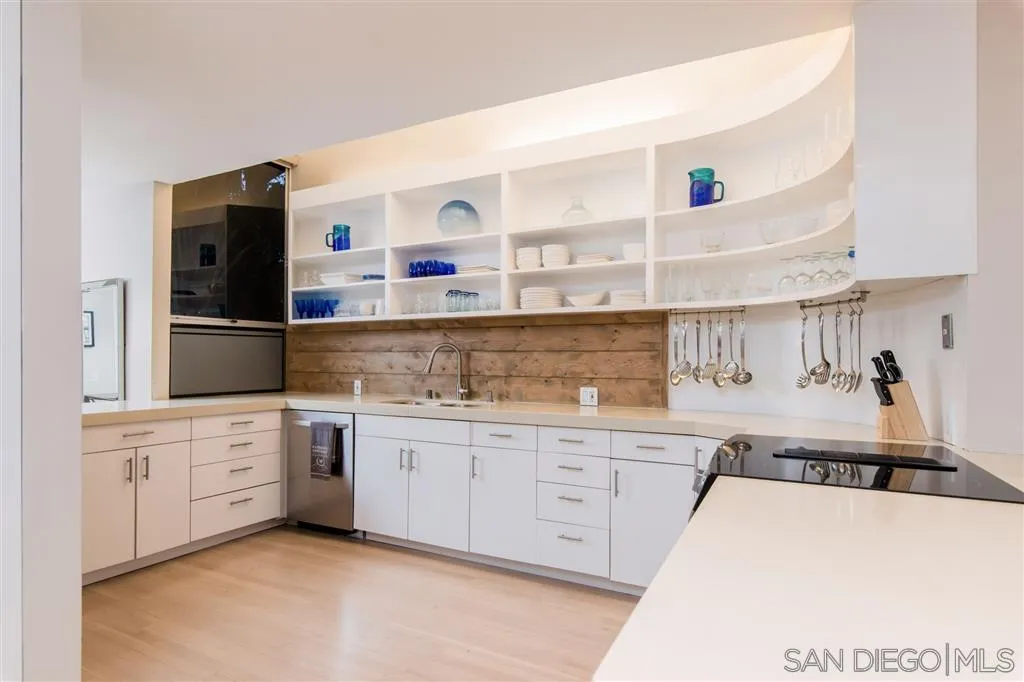 2134 Cordero Road Del Mar, CA 92014 - Photo 8 of 25 a kitchen with stainless steel appliances granite countertop a sink and cabinets