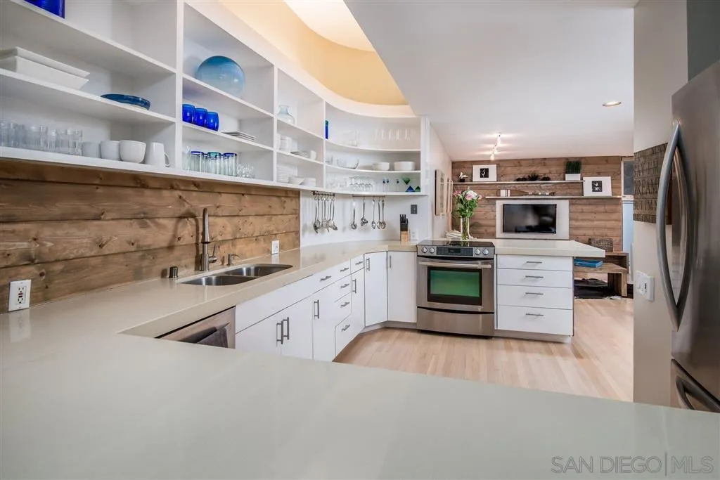 2134 Cordero Road Del Mar, CA 92014 - Photo 9 of 25 a kitchen with stainless steel appliances a refrigerator and a stove top oven