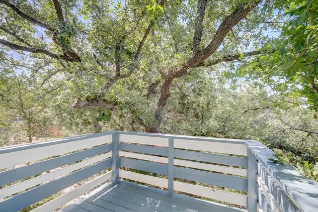 a view of wooden deck and trees
