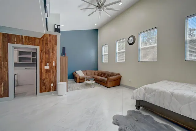 a bedroom with bed and window