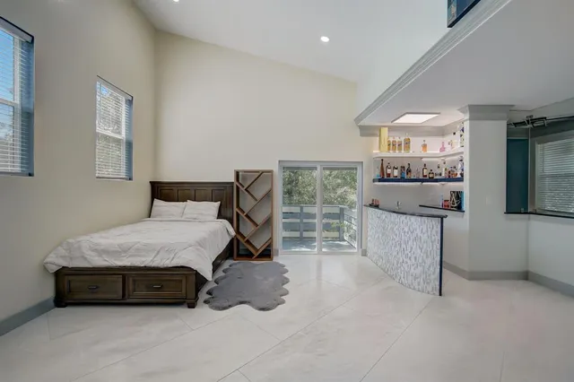 a bedroom with a bed and a large window