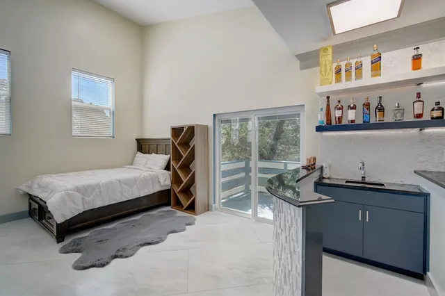 a bedroom with a bed and a dresser next to a window