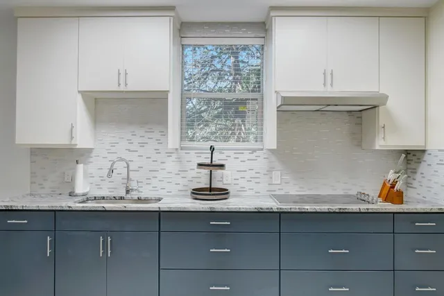 a kitchen with sink and cabinets