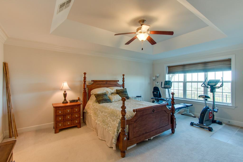 7100 Dale Ridge Road, Unit C2 Lancaster, TN 38569 - Photo 12 of 24 a bedroom with a bed and a chandelier