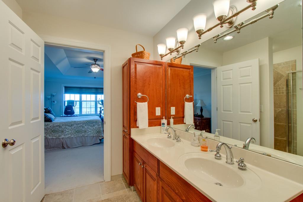 7100 Dale Ridge Road, Unit C2 Lancaster, TN 38569 - Photo 15 of 24 a en suite bathroom with a double vanity sink a mirror and a shower